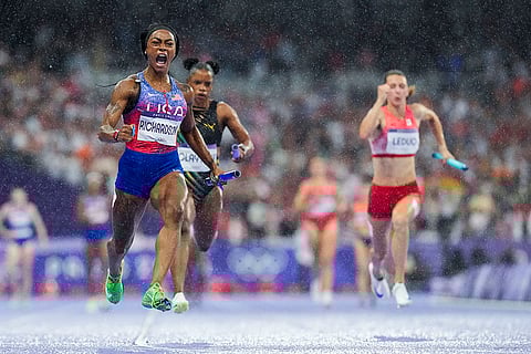 Sha'carri Richardson celebrates after winning the women's 4 x 100-meter relay final